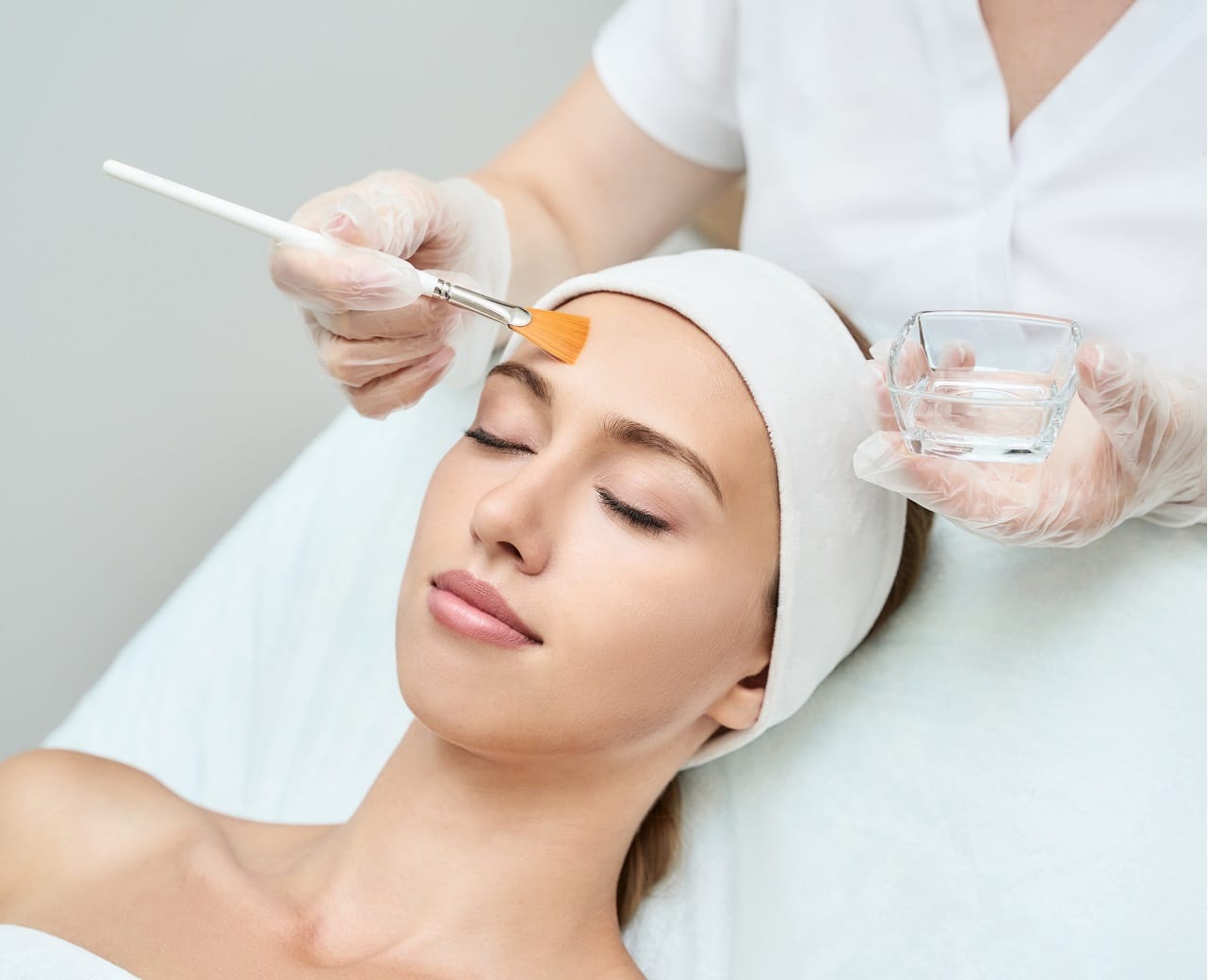 Cosmetology beauty procedure. Young woman skin care. Beautiful female person. Rejuvenation treatment. Facial chemical peel therapy. Clinical healthcare. Doctor hand. Dermatology cleanser | Aesthetic Center of Richmond Dermatology in Medical spa in Glen Allen, VA