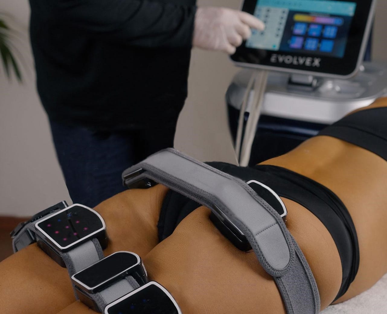 A Woman getting treatment on her butt through a Device | Body Treatments | Aesthetic Center of Richmond